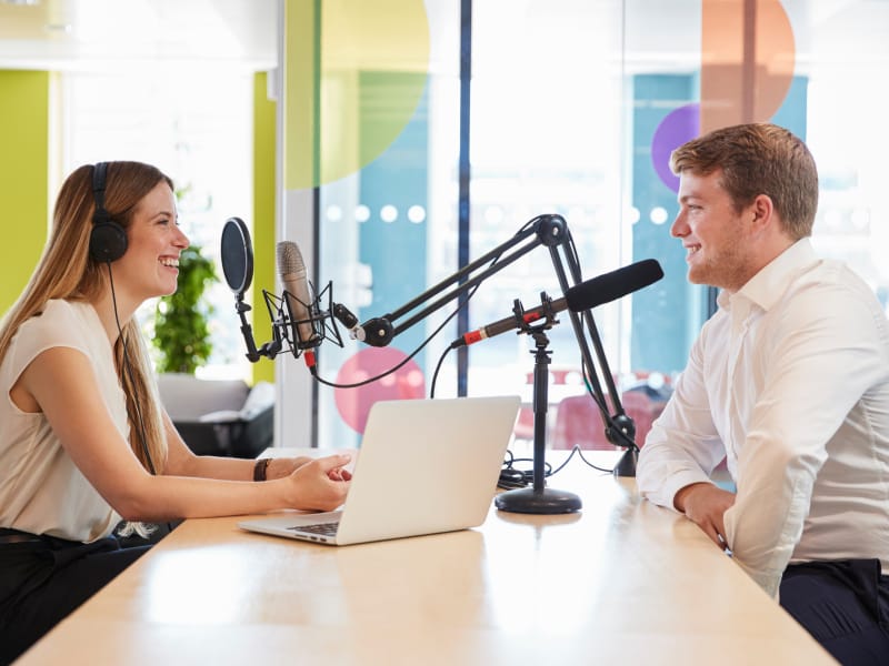 Two people recording a podcast