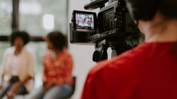 Person filming two others