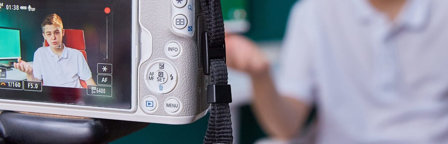 A video camera recording a student